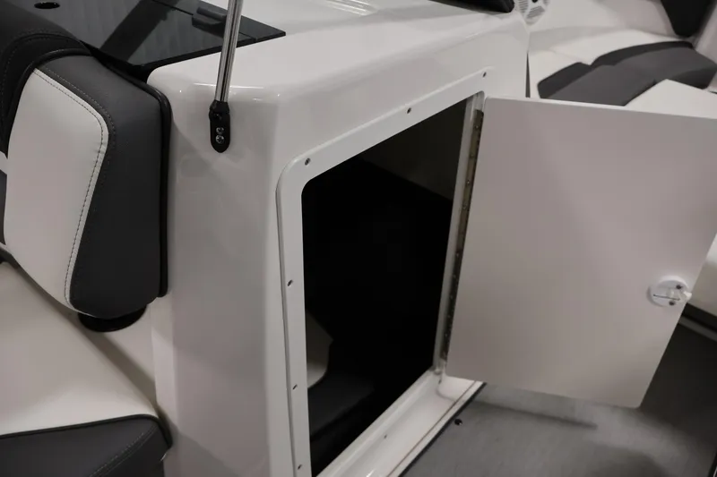 Slide: The Image of 2021 Yamaha AR210 boat interior storage compartment with open door. - 33
