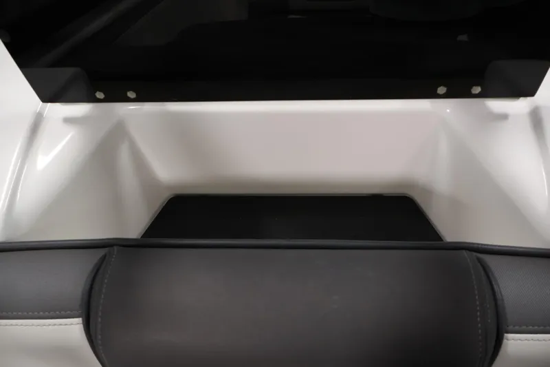 Slide: The Image of 2021 Yamaha Boats AR210 interior detail, featuring sleek seating and storage area. - 34