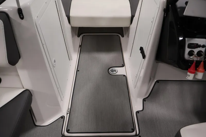 Slide: The Image of 2021 Yamaha AR210 boat interior with gray flooring and white seating. - 36