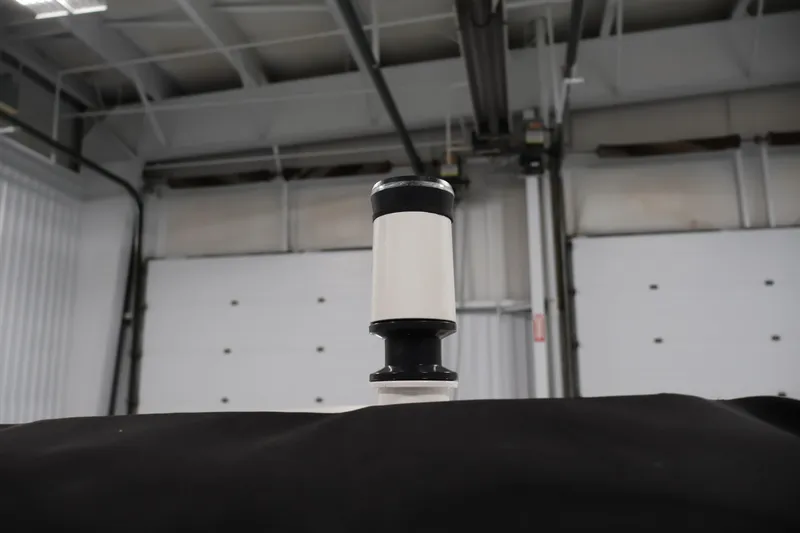 Slide: The Image of 2021 Yamaha Boats AR210 in a garage, focus on a vertical component. - 40