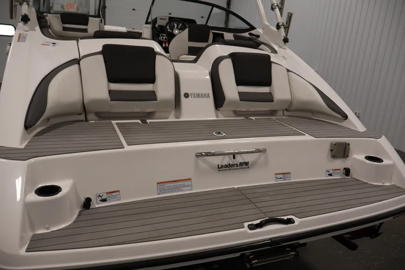 Slide: The Image of 2021 Yamaha Boats AR210 rear view showcasing seating and deck design. - 43