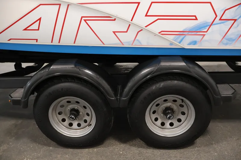 Slide: The Image of Trailer wheels of a 2021 Yamaha Boats AR210, featuring bold red graphics. - 48