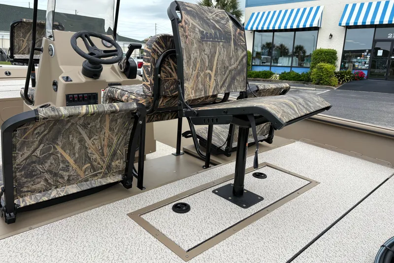 Slide: The Image of 2026 SeaArk Shadow 20V boat interior with camouflage seating and steering console. - 10