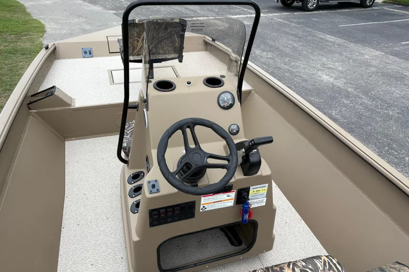 Slide: The Image of 2026 SeaArk Shadow 20V boat interior with steering console and controls. - 14