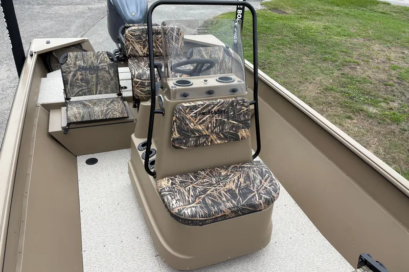 Slide: The Image of 2026 SeaArk Shadow 20V boat interior with camouflage seating and steering console. - 17
