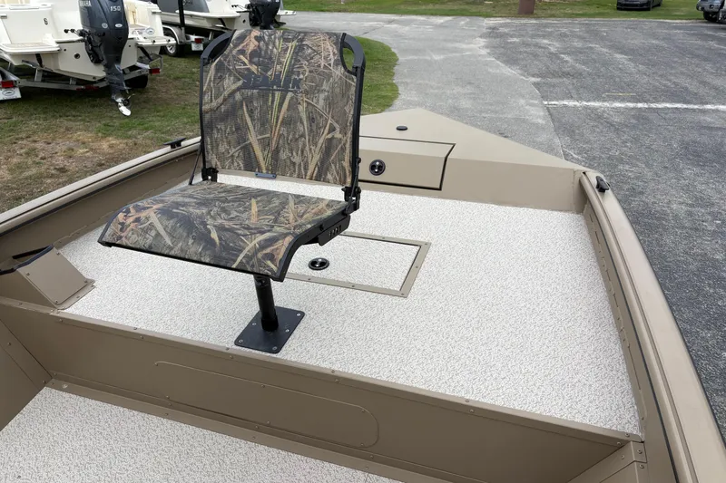 Slide: The Image of 2026 SeaArk Shadow 20V boat with camo seat, beige deck, and storage compartment. - 19