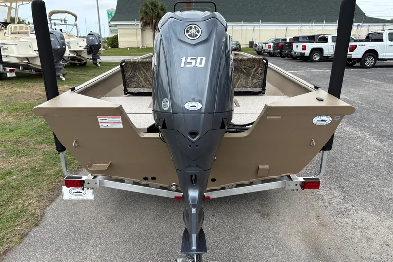 Slide: The Image of 2026 SeaArk Shadow 20V boat with a 150 HP outboard motor, parked on a trailer. - 2