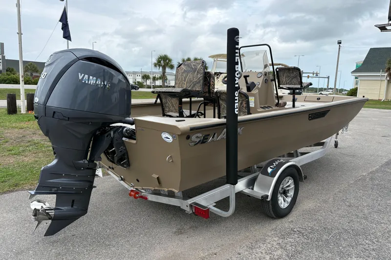 Slide: The Image of 2026 SeaArk Shadow 20V boat with Yamaha engine on a trailer, parked outdoors. - 3