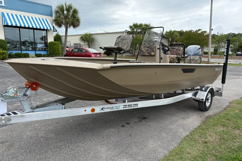 Slide: The Image of 2026 SeaArk Shadow 20V boat on trailer, parked outdoors near a dealership. - 7