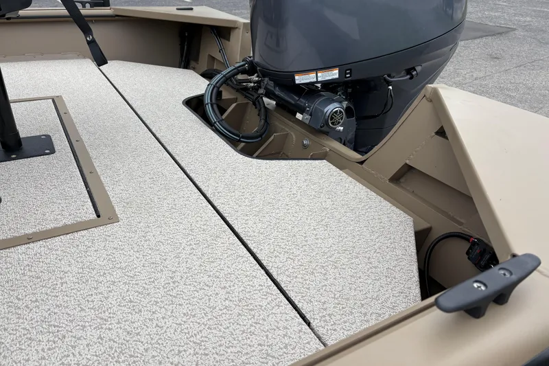 Slide: The Image of 2026 SeaArk Shadow 20V boat interior with motor, featuring textured flooring and storage compartments. - 8