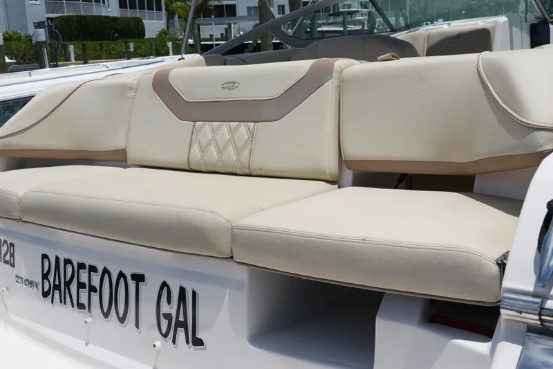 Slide: The Image of 2019 Regal 23 OBX boat with beige seating and "Barefoot Gal" name displayed. - 13