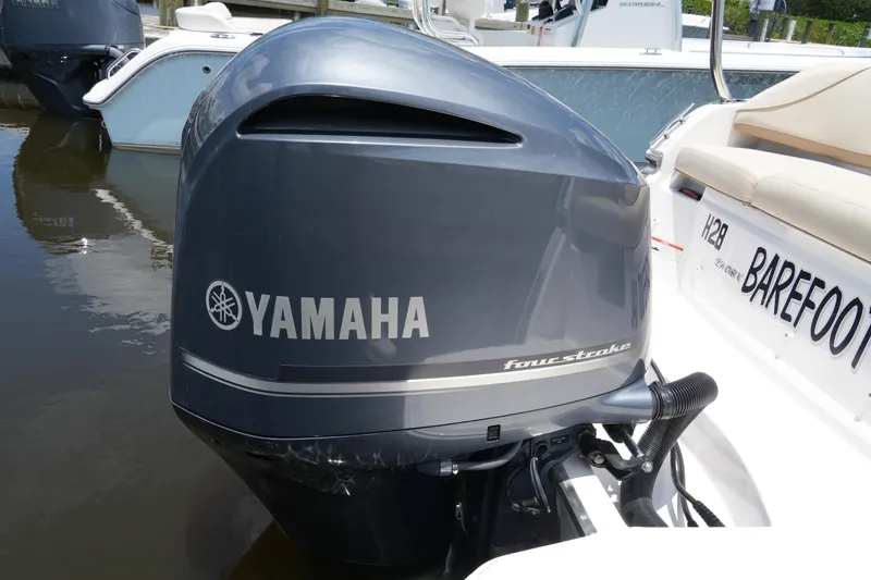 Slide: The Image of 2019 Regal 23 OBX with Yamaha four-stroke outboard motor, docked on calm water. - 14