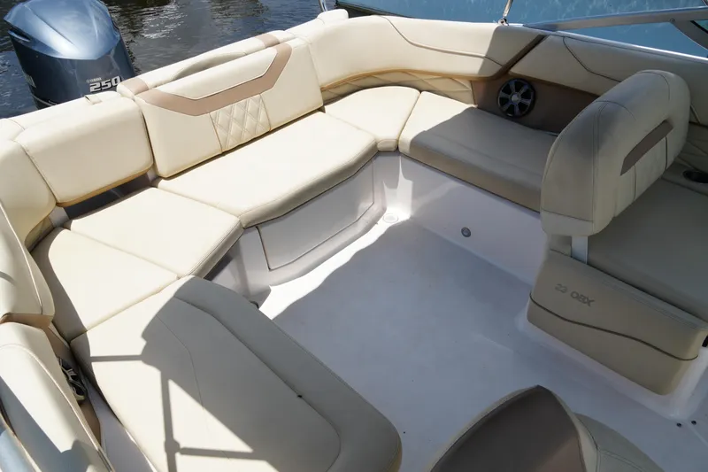 Slide: The Image of Luxurious seating area on a 2019 Regal 23 OBX boat, featuring beige upholstery. - 17