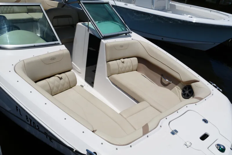 Slide: The Image of 2019 Regal 23 OBX boat with beige seating and open bow design. - 18