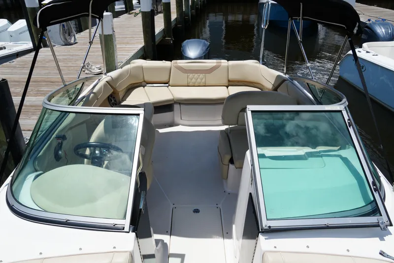 Slide: The Image of 2019 Regal 23 OBX boat with spacious seating and sleek design at a dock. - 19