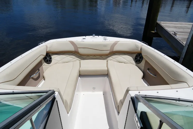 Slide: The Image of 2019 Regal 23 OBX boat interior with beige seating and waterfront view. - 20