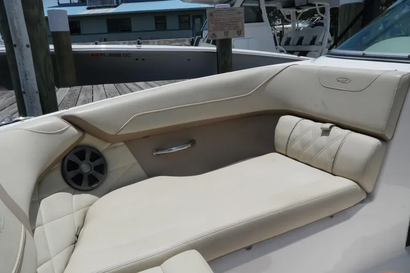Slide: The Image of 2019 Regal 23 OBX boat interior with beige seating and speaker. - 21