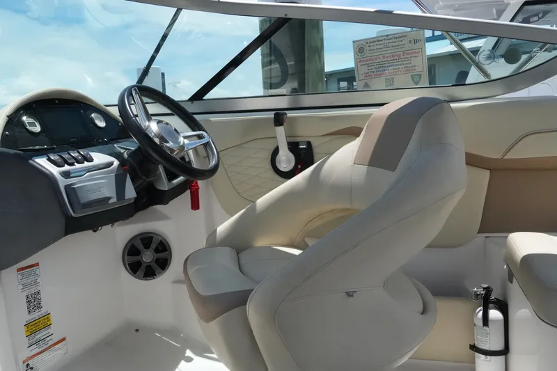 Slide: The Image of Interior of a 2019 Regal 23 OBX boat featuring steering wheel and seating. - 24