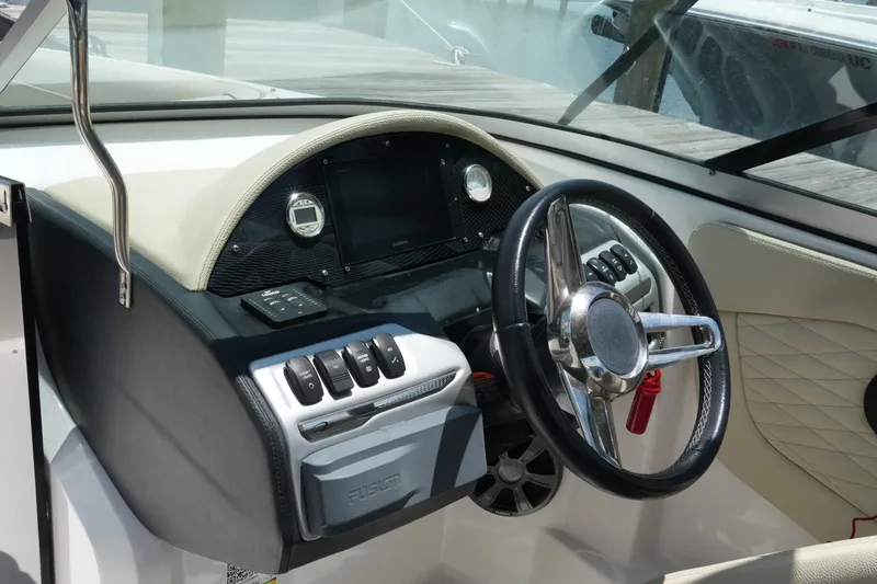 Slide: The Image of Cockpit of 2019 Regal 23 OBX boat with steering wheel and control panel. - 25