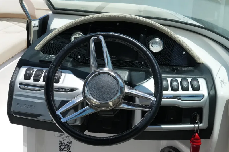 Slide: The Image of Steering wheel and dashboard of a 2019 Regal 23 OBX boat. - 26