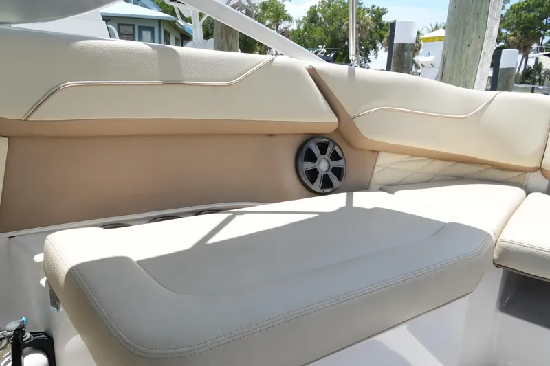 Slide: The Image of Interior seating of a 2019 Regal 23 OBX boat with beige upholstery and speaker. - 28