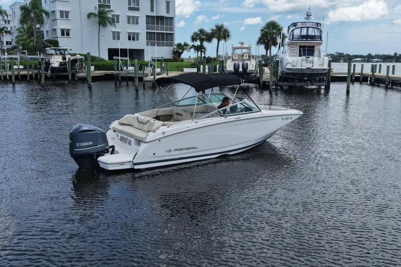 Slide: The Image of 2019 Regal 23 OBX boat with Yamaha engine docked in a marina. - 3