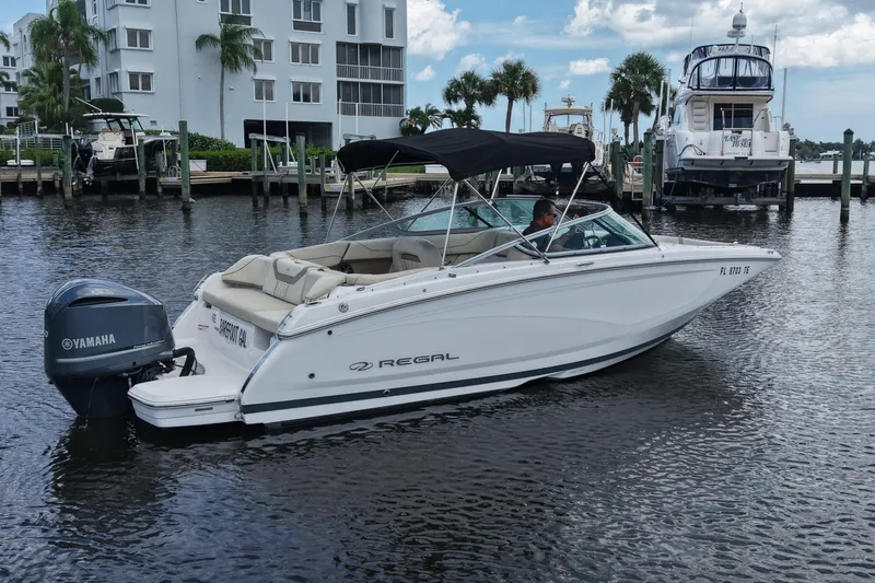 Slide: The Image of 2019 Regal 23 OBX boat with Yamaha engine docked near waterfront buildings. - 4