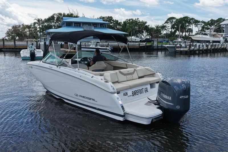 Slide: The Image of 2019 Regal 23 OBX boat with Yamaha engine on a calm waterway. - 7