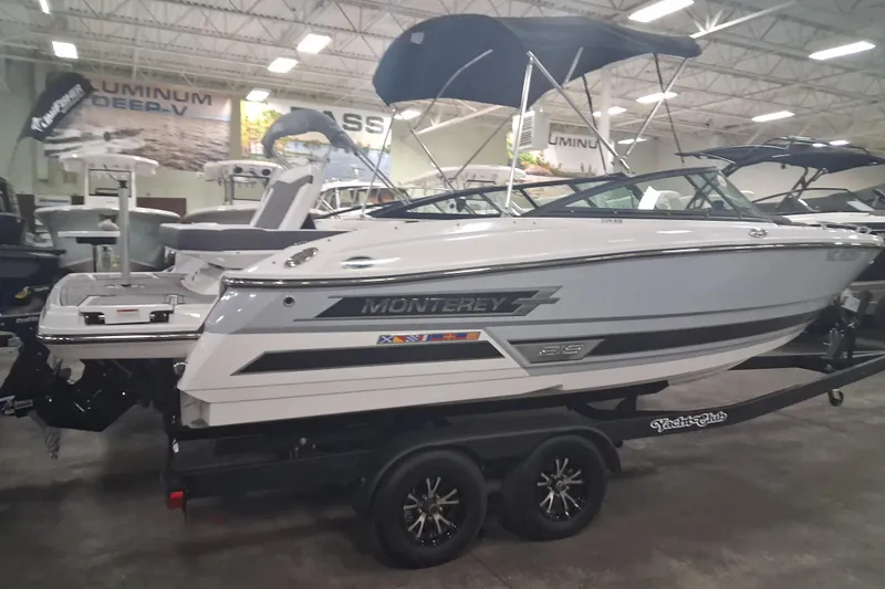 The Image of 2022 Monterey 218SS Super Sport boat displayed indoors on a trailer. - 0
