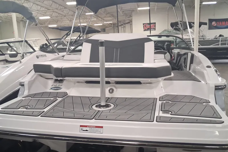 Slide: The Image of 2022 Monterey 218SS Super Sport boat with sleek seating and modern design in showroom. - 2