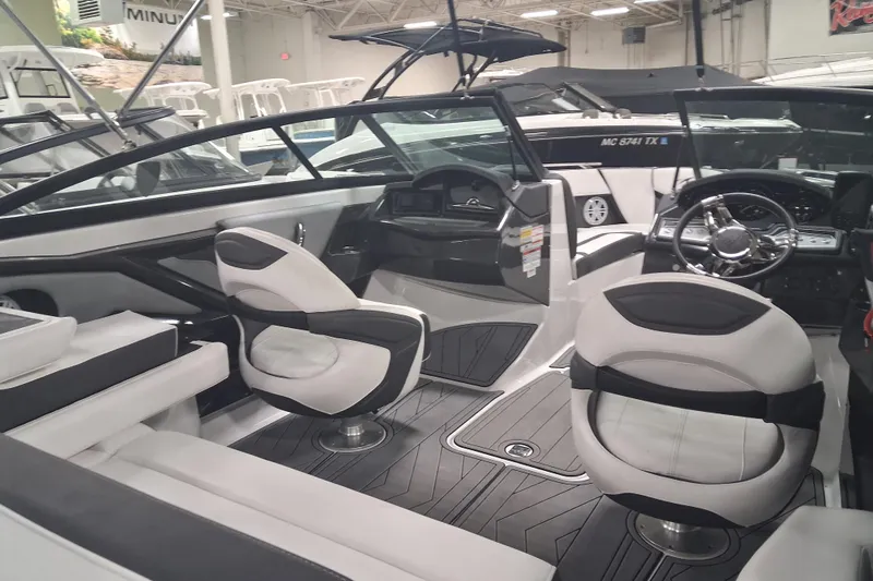 Slide: The Image of 2022 Monterey 218SS Super Sport boat interior with modern seating and sleek dashboard design. - 7