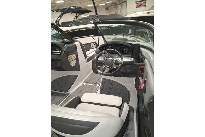 Slide: The Image of Interior view of 2022 Monterey 218SS Super Sport boat, featuring sleek dashboard and steering wheel. - 9