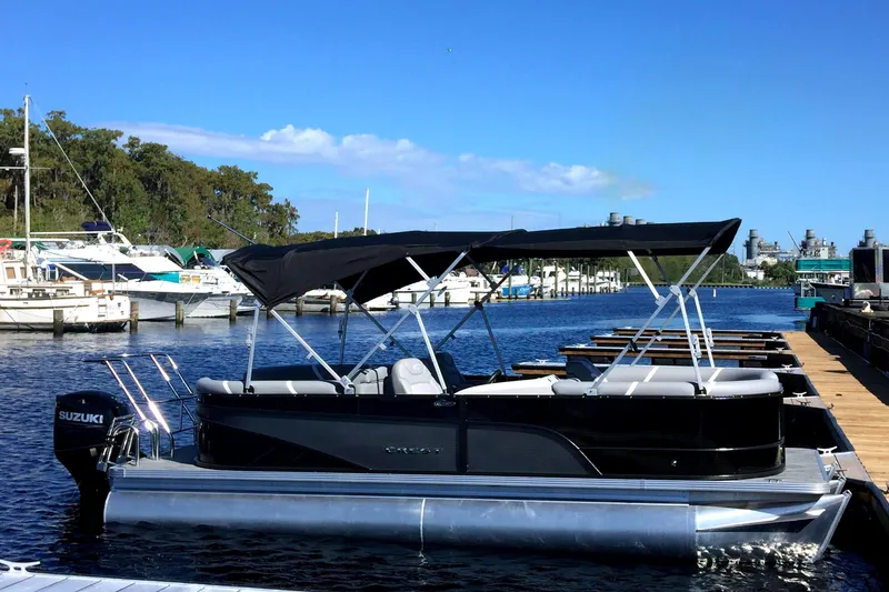 The Image of 2023 Crest Classic DLX 220 SLC pontoon boat docked at marina. - 0