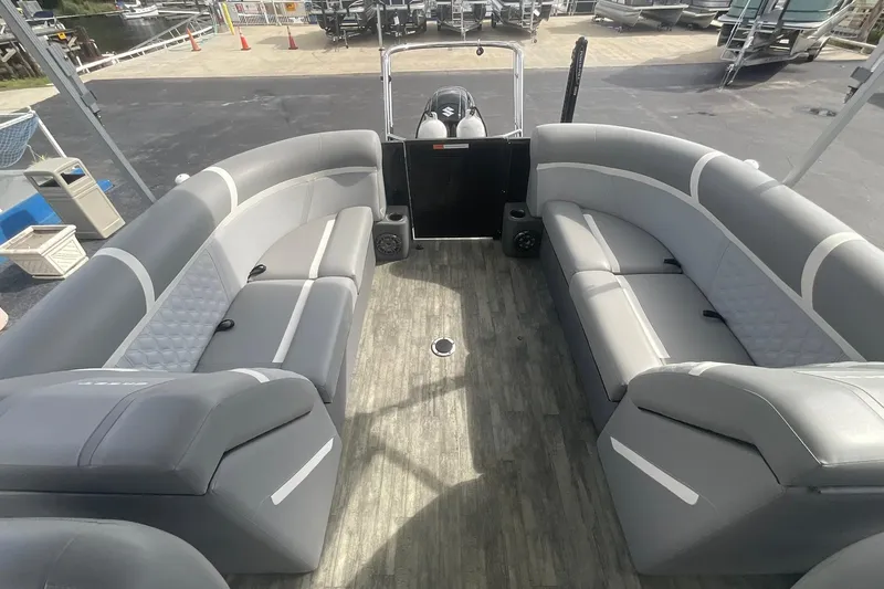 Slide: The Image of 2023 Crest Classic DLX 220 SLC pontoon boat interior with gray seating and wood-style flooring. - 19