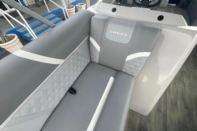 Slide: The Image of 2023 Crest Classic DLX 220 SLC boat interior with elegant gray seating and quilted design. - 22