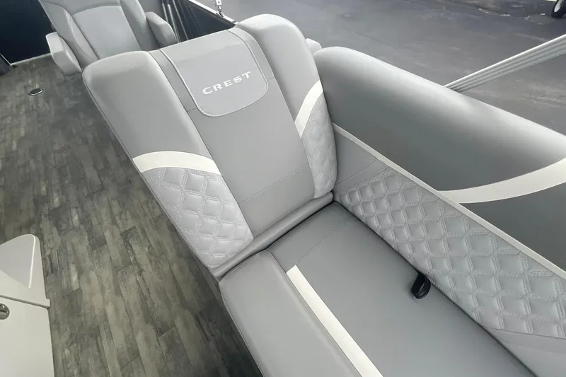 Slide: The Image of 2023 Crest Classic DLX 220 SLC boat interior with elegant gray seating. - 23