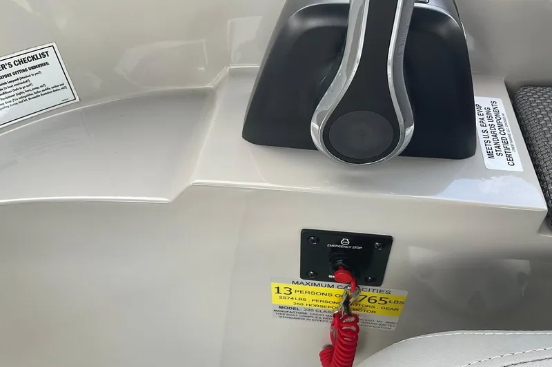 Slide: The Image of Control panel of 2023 Crest Classic DLX 220 SLC boat with emergency stop switch. - 26