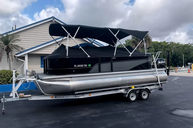 Slide: The Image of 2023 Crest Classic DLX 220 SLC pontoon boat on trailer. - 4