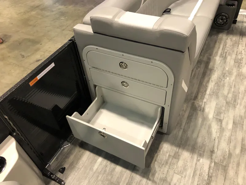 Slide: The Image of 2023 Crest Classic DLX 220 SLC boat with open storage compartment. - 6