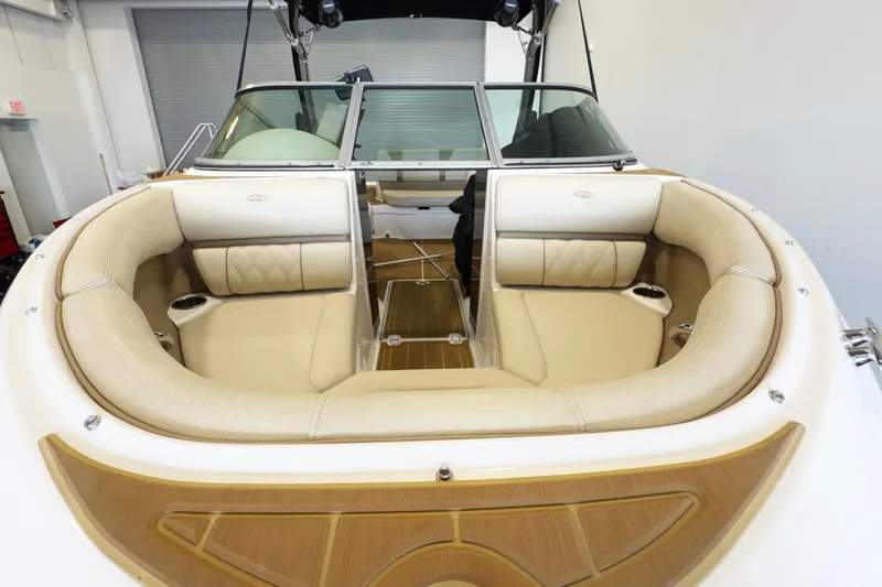 Slide: The Image of 2018 Regal 2000 ES Bowrider with beige seating and wood accents in a showroom. - 4