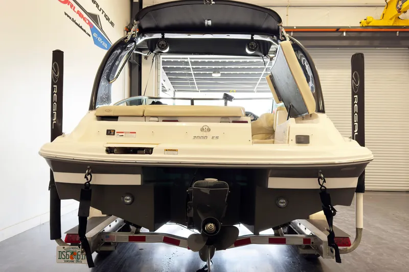 Slide: The Image of 2018 Regal 2000 ES Bowrider boat in showroom, rear view, on trailer. - 5