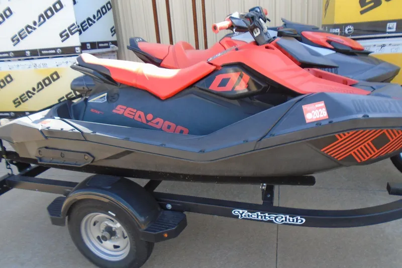 Slide: The Image of 2022 Sea-Doo Spark Trixx 3up jet ski on trailer, vibrant red and black design. - 2
