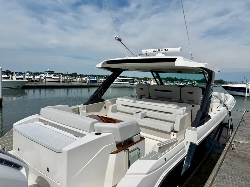 Slide: The Image of The 2027 Tiara Yachts 43LS is docked. It features a spacious aft deck with seating. - 34