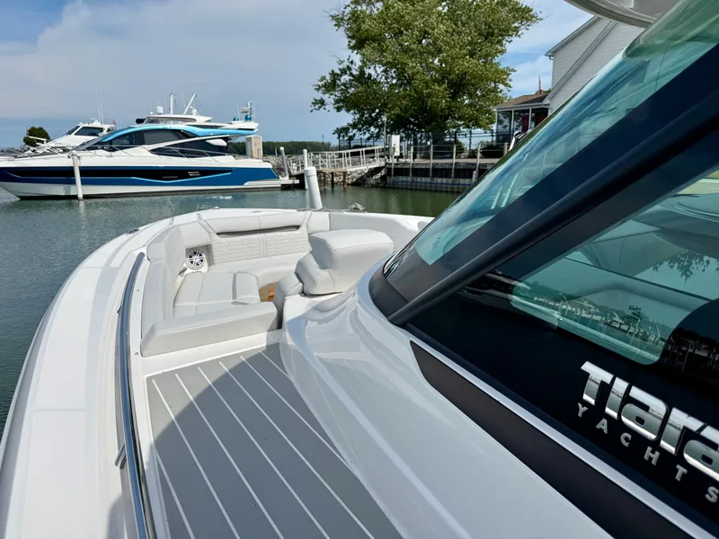 Slide: The Image of The image shows a 2027 Tiara Yachts 43LS docked. The foredeck area is spacious and modern. - 9
