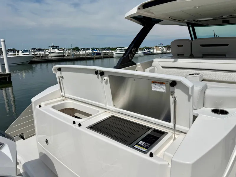 Slide: The Image of The 2027 Tiara Yachts 43LS features a modern outdoor kitchen with a grill and sink. - 7