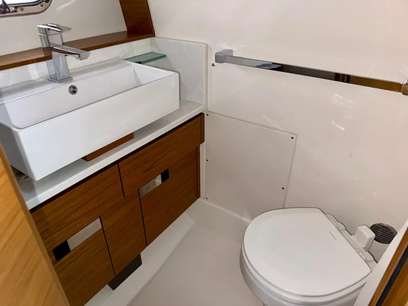Slide: The Image of The image shows a modern yacht bathroom with a sink and toilet. - 28