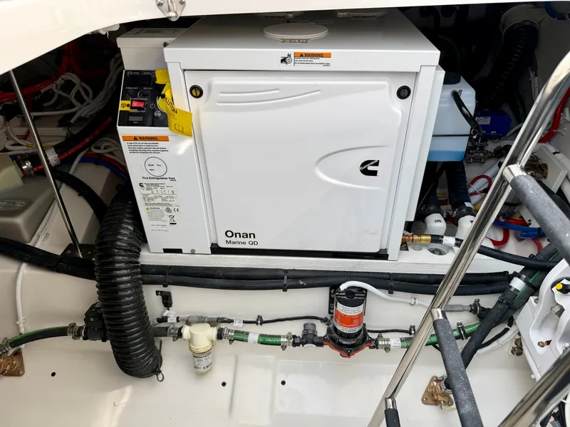 Slide: The Image of An Onan Marine Generator in the engine room of a 2027 Tiara Yachts 43LS. - 40