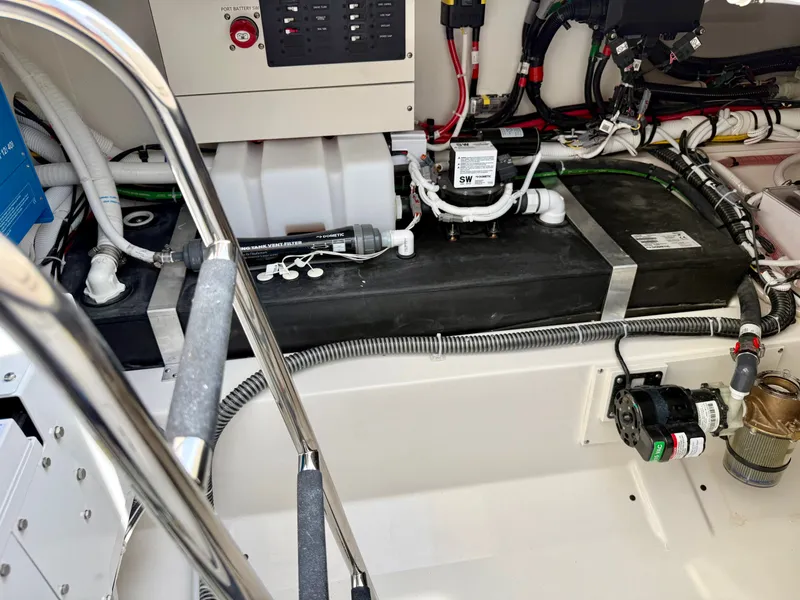 Slide: The Image of The engine room of a 2027 Tiara Yachts 43LS shows wiring and technical components. - 39