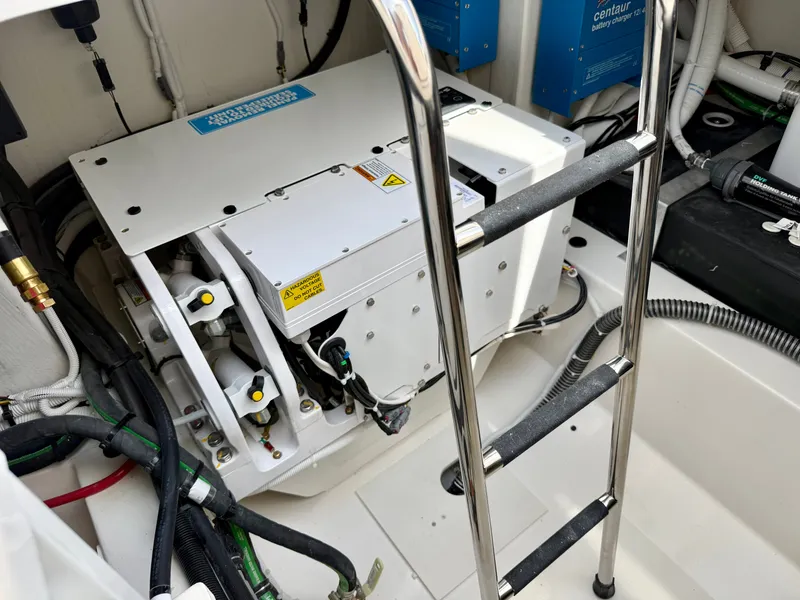 Slide: The Image of The engine room of a 2027 Tiara Yachts 43LS with modern equipment and a ladder. - 41