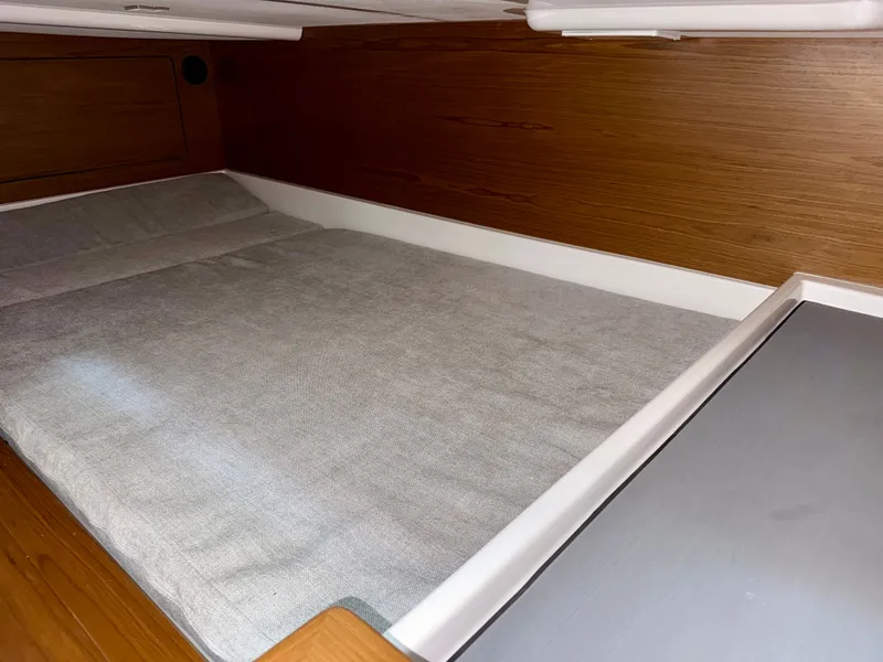 Slide: The Image of Interior of a 2027 Tiara Yachts 43LS featuring a cozy bed and wood paneling. - 33